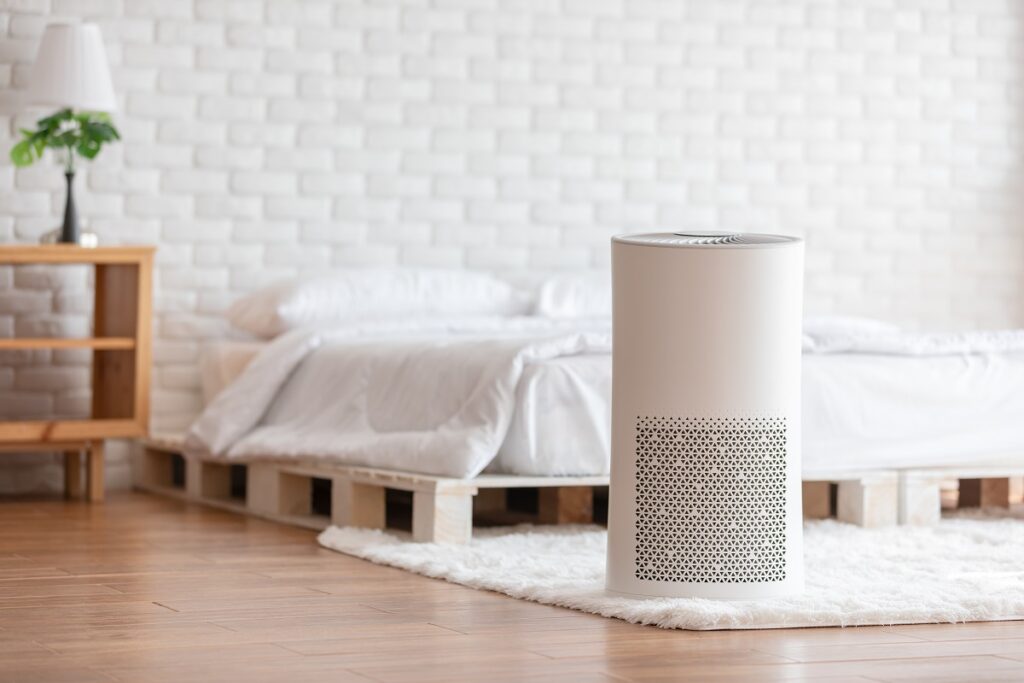Air purifier in cozy white bedroom for filter and cleaning removing dust PM2.5 HEPA in home,for fresh air and healthy life,Air Pollution Concept